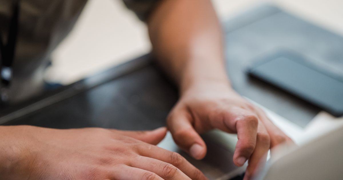 Close-up of hands typing on a keyboard